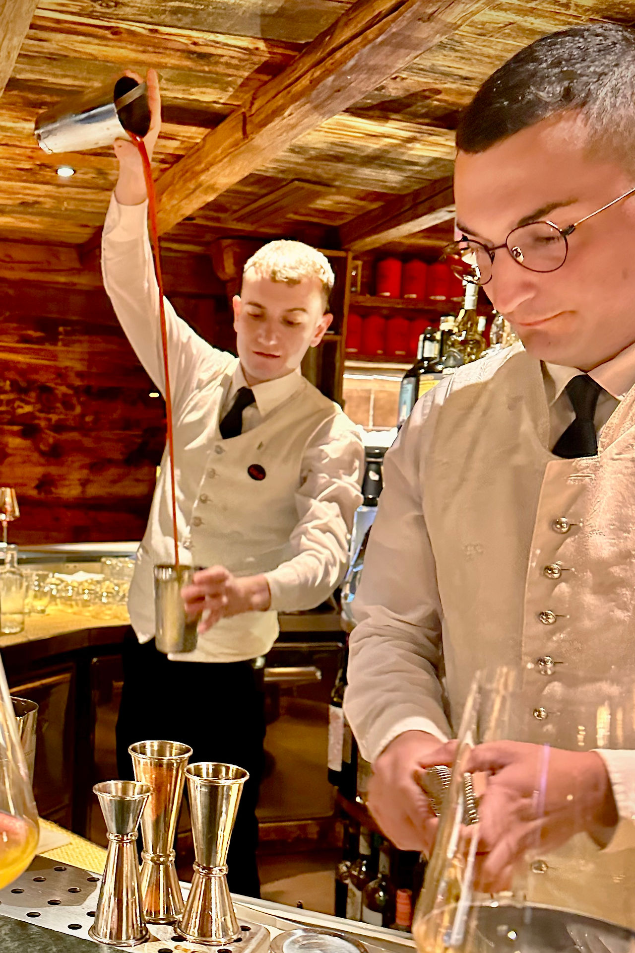 Bartenders plying their trade at La Perla in formal uniforms Credit: Holman Photography
