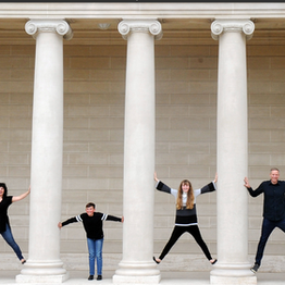 family poses for a portrait session at san francisco's legion of honor columns