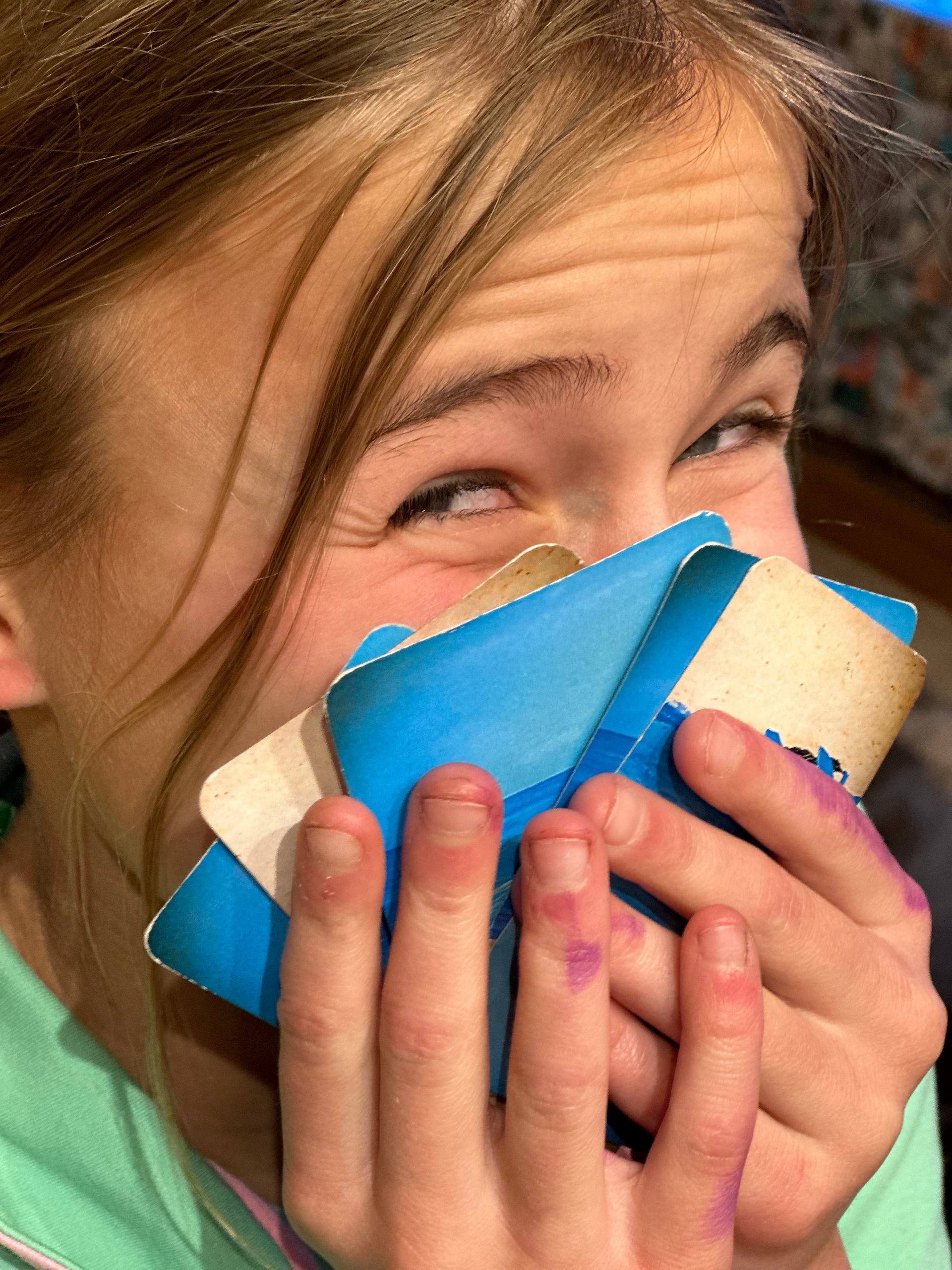 Child delighted with the card hand she holds