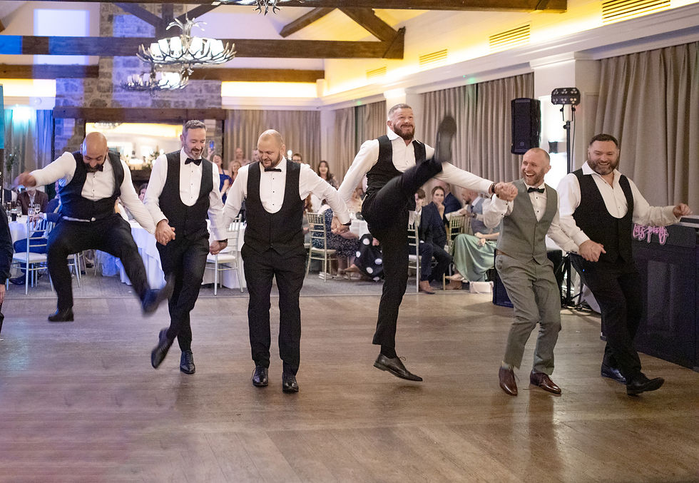 Groom and groomsmen dancing Irish tunes