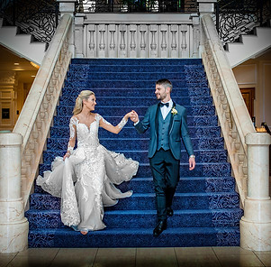 Couple walking down a beautiful blue staircase