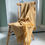 Thumbnail: Yellow herringbone pattern throw with yellow fringing draped over a wooden chair