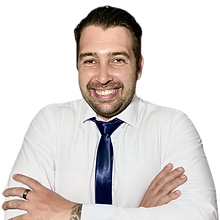 Portrait of a smiling man in a white shirt and blue tie with arms crossed, representing the founder of Hill Education and pro