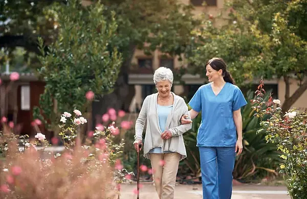 adult-going-for-walk-with-caregiver.webp