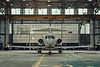 vecteezy_a-small-jet-airplane-parked-in-an-open-hangar_50434389.jpeg