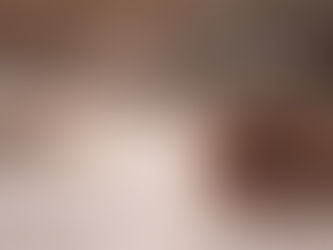 Chikankari artisan hand-embroidering white fabric with needle and thread in natural light