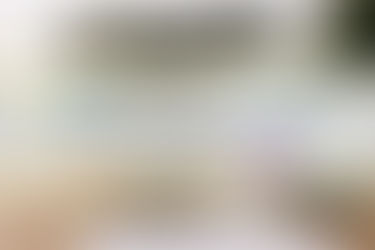 BRRRR strategy explained with real estate investing concept – stacked coins, house model, mortgage documents, and calculator in front of home symbolizing equity growth, cash flow, and refinancing.