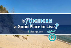 Sleeping Bear Dunes National Lakeshore with golden sand dunes along Lake Michigan under a bright blue sky – highlighting why many ask, “Is Michigan a good place to live?” - thumbnail