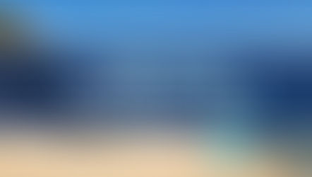 Sleeping Bear Dunes National Lakeshore with golden sand dunes along Lake Michigan under a bright blue sky – highlighting why many ask, “Is Michigan a good place to live?” - thumbnail