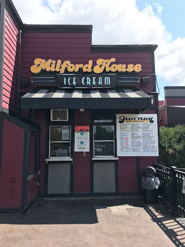 Front of Milford House Ice Cream shop in downtown Milford, MI with signage and outdoor seating