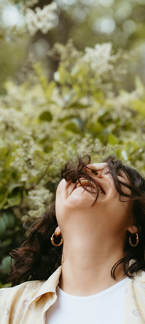 Smiling woman surrounded by white blossoms beside the “Be Limitless” phase about sustaining habits and continued growth.