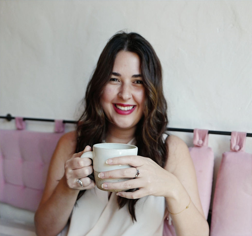 girl sipping coffee in pink cafe