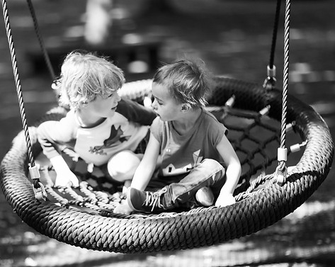 brothers-playing-on-a-swing-in-the-park.