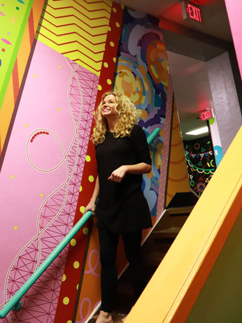 Colorful vinyl mural installation throughout Immanuel Church hallways and staircases, designed to create an immersive and engaging environment with playful graphics that connect across the space.
