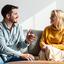 two people in a comfortable setting talking man and woman.jpg