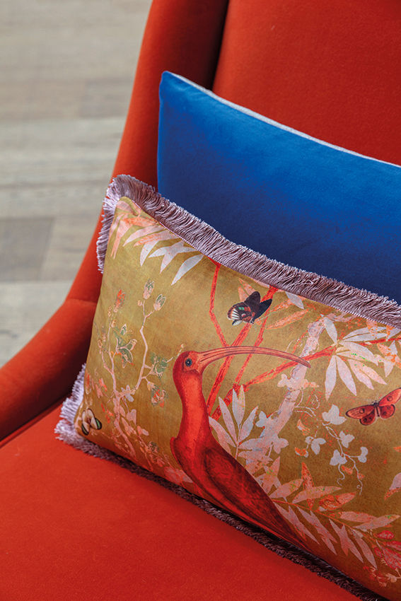 High angle view of a stylish sofa with a mix of linen and velvet cushions