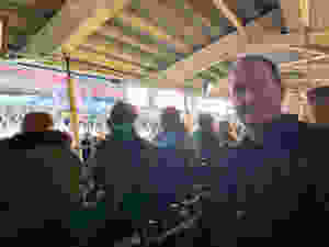 Ross's dad sat at his seat, with the stage in the background before the show