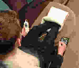 An aeriel shot of Ross with his feet in the foot warmer, holding the temperature control