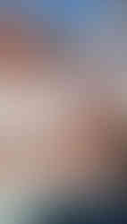 Tanya holding a red snake and smiling