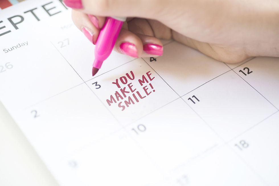 A mom writes "You make me smile!" on a calendar for her child to find