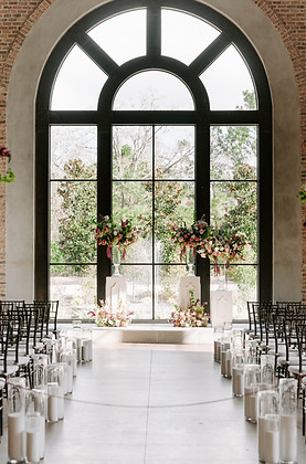 Romantic Iron Manor wedding ceremony with elevated floral arrangements and soft pastel blooms