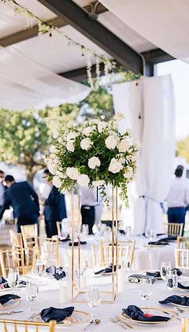 Luxury reception tablescape with tall white floral centerpieces and elegant ranch wedding decor