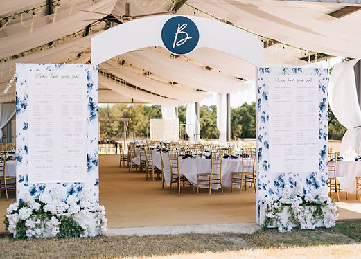 Statement seating chart display creating a tunnel entrance into the draped pavilion wedding reception