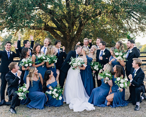 Elegant bridal party portrait at a Texas ranch wedding with royal blue and white details