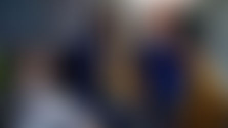 four people standing around office