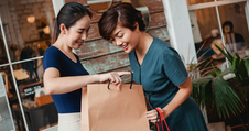two women looking into shopping bag