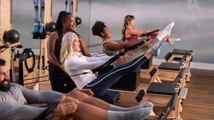 people exercising on Pilates reformers