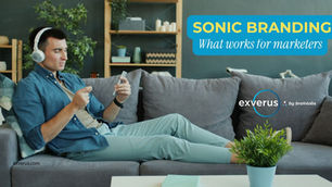 Man with headphones lounging on a gray sofa, using a smartphone; promo text reads Sonic Branding: What works for marketers.