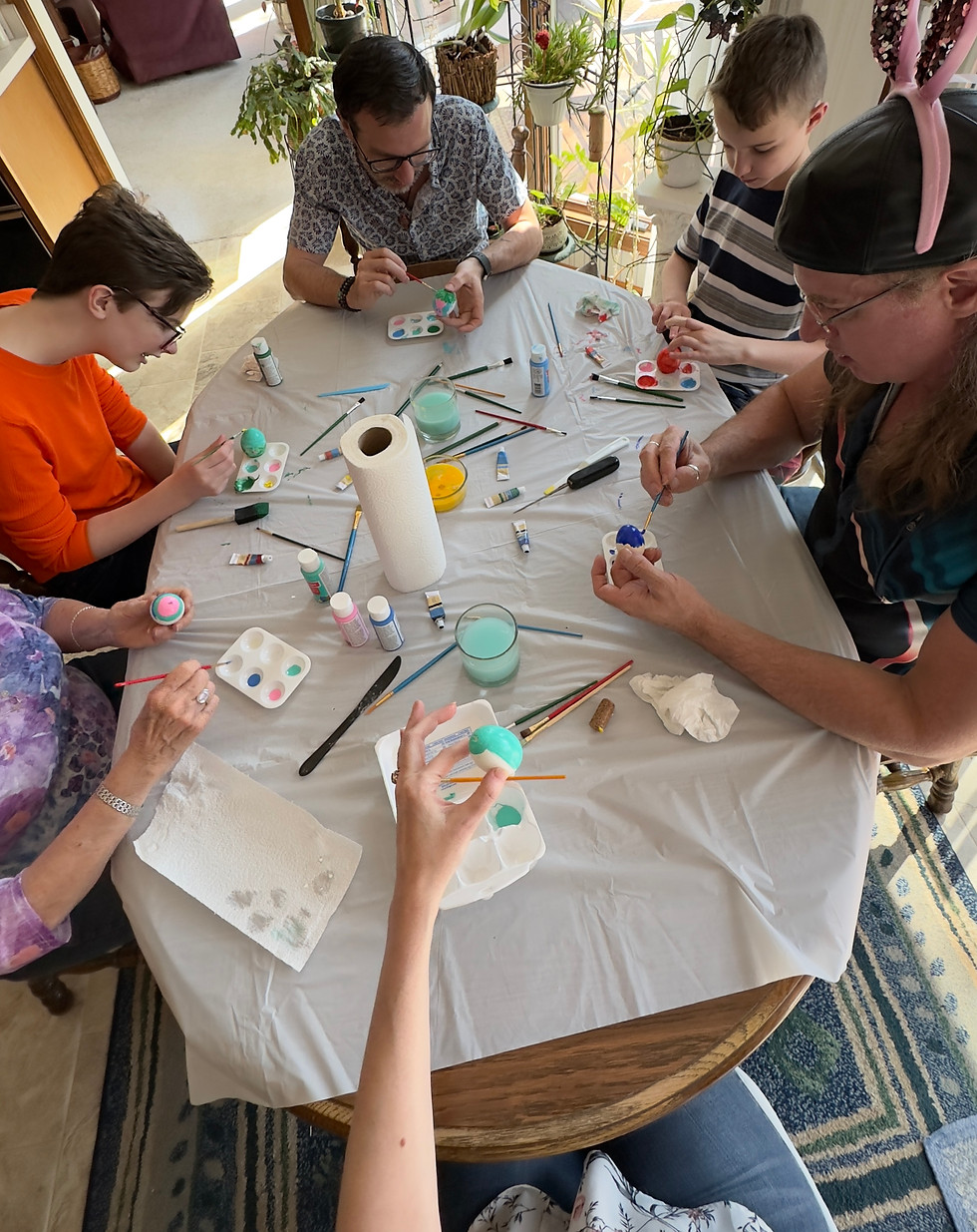 Adults and children painting together during a creative hands-on experience