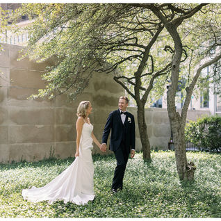bride and groom walking in ivy garden
