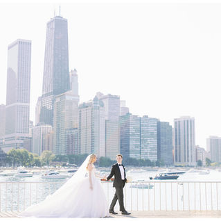 bride and groom walking along the lakefront at olive park