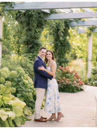 engaged couple posing in garden