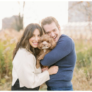 couple with poodle hugging