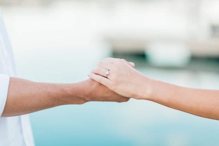 couple holding hands showing off engagement ring in chicago illinois