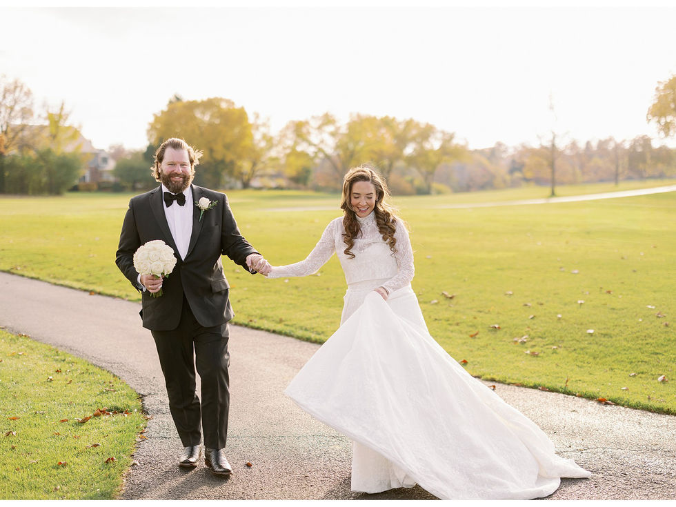 bride and groom walking on a trail