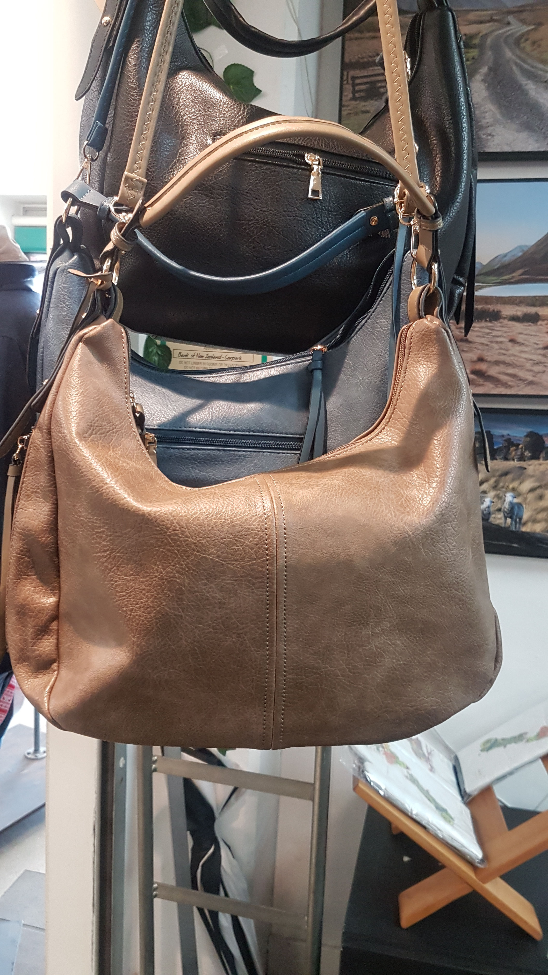 Brown leather shoulder bag in a rack; Small Leather bag for sale