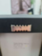 Thumbnail: Metal sawtooth picture hanger on the back of a framed picture.