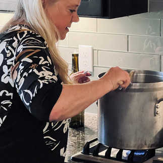 Treva stirring cioppino in pot