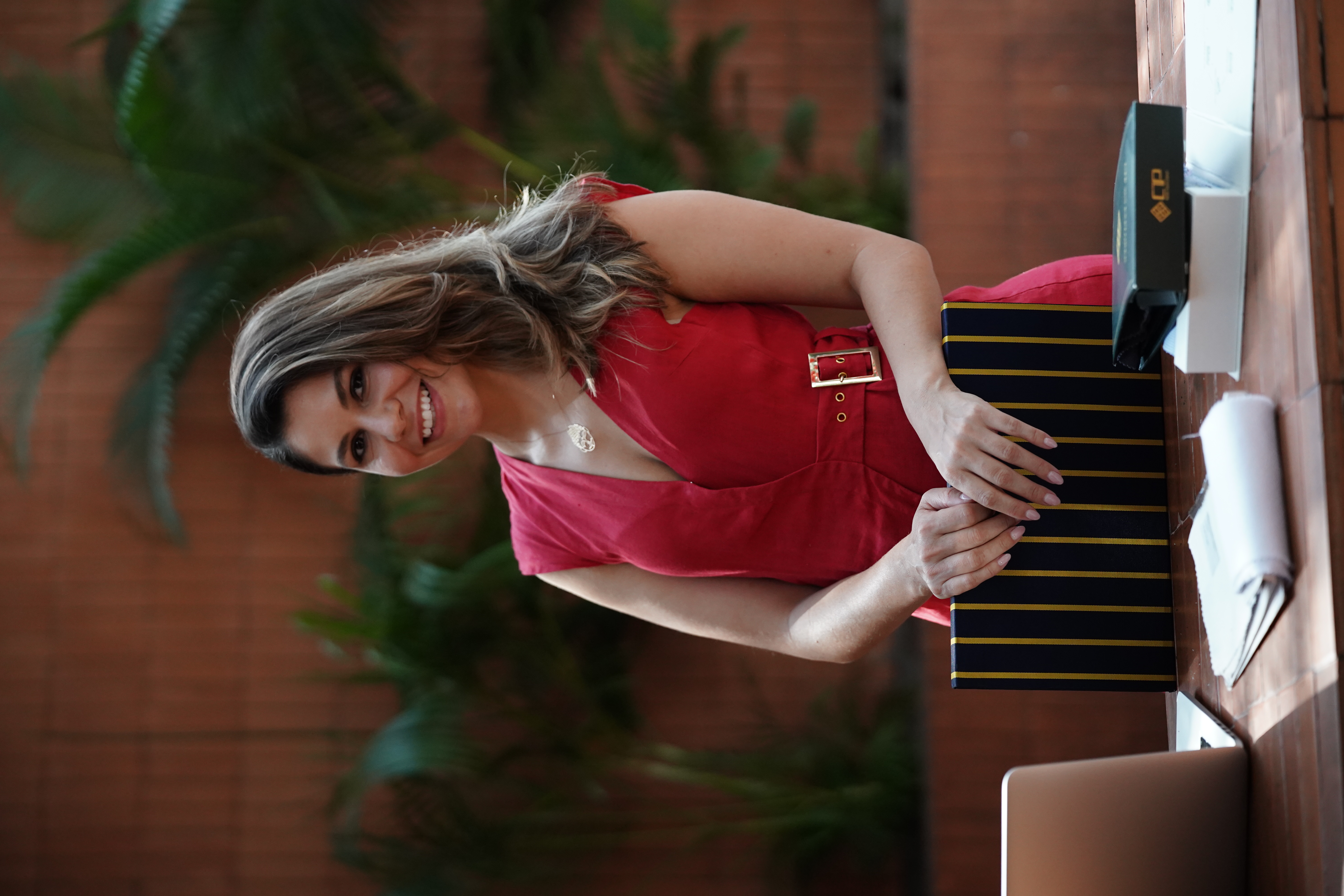 Sanctuario founder in a confident pose, red dress, Vietnam.