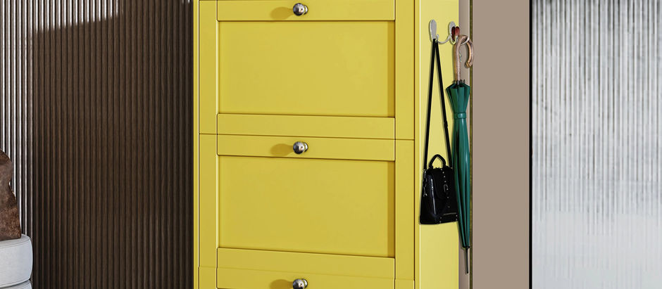 Bright yellow shoe cabinet with three flip-down drawers, decorated with a handbag and vase, placed in a modern entryway.