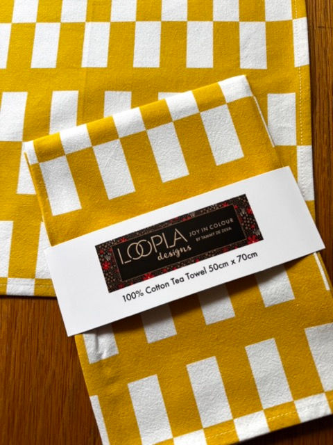 Folded Jagged cotton tea towel with Loopla brand belly band packaging. This absorbent flour sack kitchen towel is desig