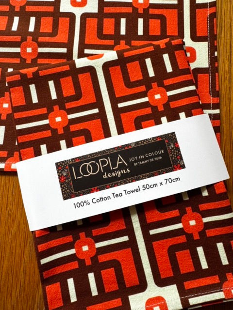 Folded Lattice Love cotton tea towel with Loopla brand belly band packaging. This absorbent flour sack kitchen towel is desig