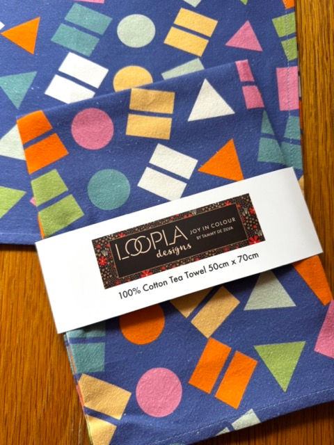 Folded Confetti Pop cotton tea towel with Loopla brand belly band packaging. This absorbent flour sack kitchen towel is desig