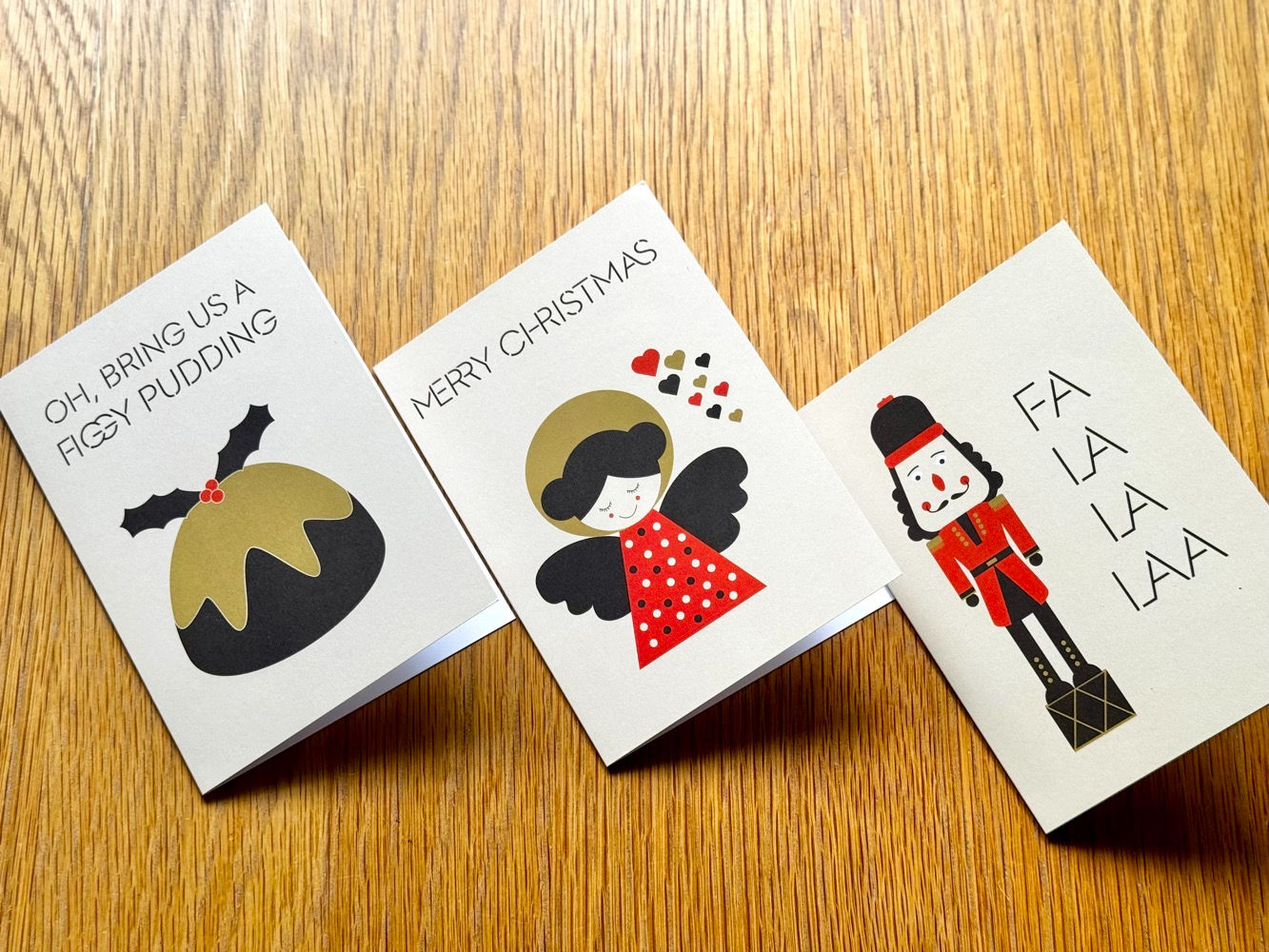 A set of three colourful retro-inspired Christmas cards, displayed side-by-side to showcase the three unique designs.