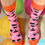 Thumbnail: An 80's inspired geometric designed sock in pink, orange and navy blue designed by Loopla