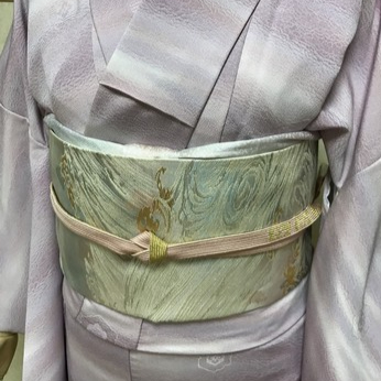 薄紫色の着物に合わせられた上品な袋帯の帯締め姿